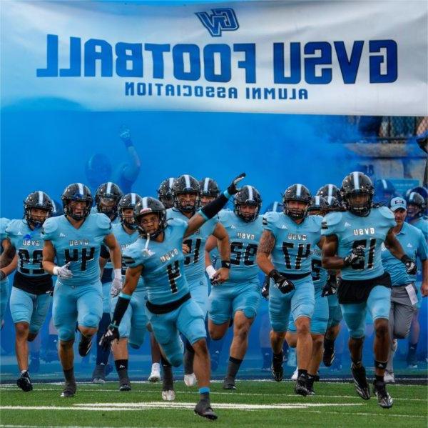 Grand Valley football team runs on the field at start of game